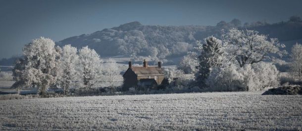 A rural UK home in a snow covered scene