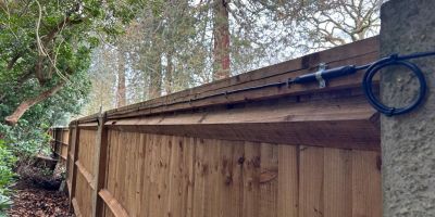 An El-Far Elec Sens Wooden Fence detection system mounted on a wooden fence.