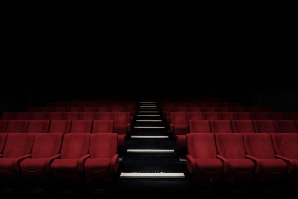 A picture of seating in a theatre with a darkened background