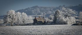 A rural UK home in a snow covered scene
