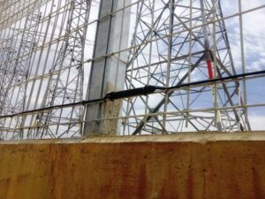 A close up shot of an Elec Sens motion sensor mounted to a fence.
