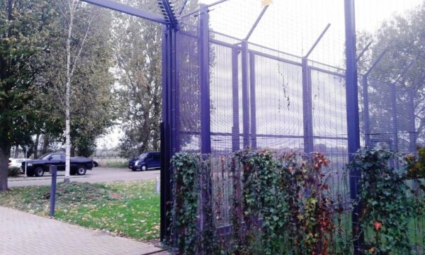 A perimeter fence with an Elec Sens motion sensor detector kit mounted to it.