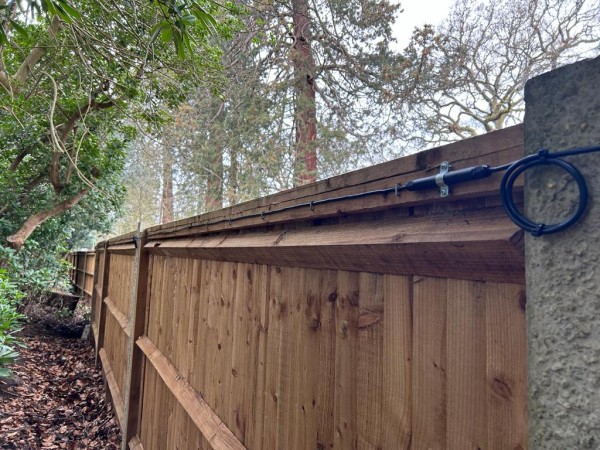 An El-Far Elec Sens Wooden Fence detection system mounted on a wooden fence.