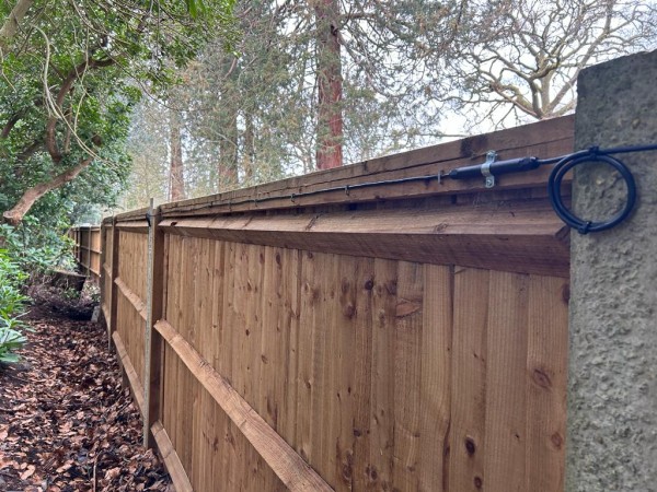 An El-Far Elec Sens Wooden Fence detection system mounted on a wooden fence.