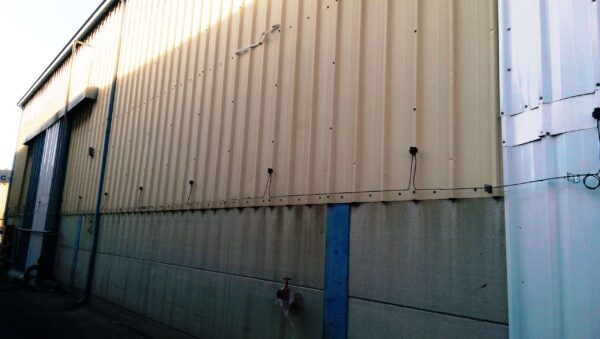 A string of Spider Sens sensors mounted along a building wall.