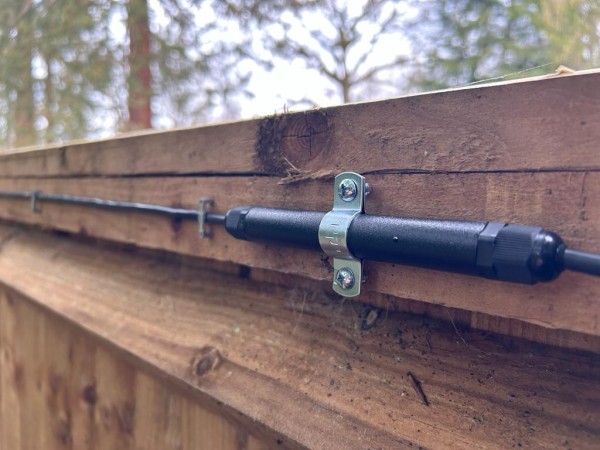 An El-Far Elec Sens Wooden Fence detection system mounted on a wooden fence.